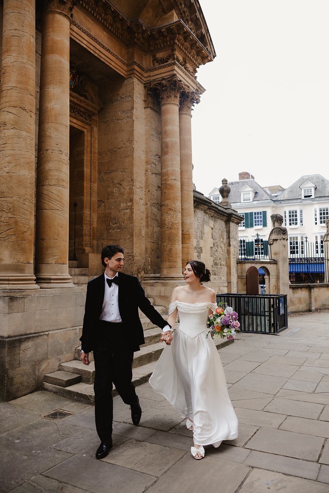 Wedding couple outside of the sciende museum steps by the bodleian library in Oxford